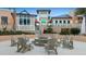 Outdoor seating area featuring a central stone fire pit surrounded by comfortable Adirondack chairs at 1644 Tropical Palms Cir, Kissimmee, FL 34747