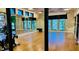 Bright fitness center with wood floors, large mirrors, and natural light streaming through the windows at 1644 Tropical Palms Cir, Kissimmee, FL 34747