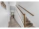 Hallway with carpeted stairs, wood railing, and a view into the dining area at 1644 Tropical Palms Cir, Kissimmee, FL 34747