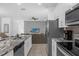 Modern kitchen showcasing stainless steel appliances, granite countertops, and open layout at 1644 Tropical Palms Cir, Kissimmee, FL 34747