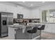 Bright kitchen featuring granite countertops, stainless steel appliances, and bar stool seating at 1644 Tropical Palms Cir, Kissimmee, FL 34747
