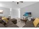 Bright living room featuring neutral walls, tile flooring, and a comfortable sectional sofa at 1644 Tropical Palms Cir, Kissimmee, FL 34747
