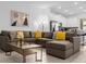 Inviting living room with a large sectional sofa, modern art, and an open layout to the kitchen at 1644 Tropical Palms Cir, Kissimmee, FL 34747