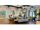 A comfortable lobby area with upscale neutral furniture, plants, and herringbone wood flooring at 1644 Tropical Palms Cir, Kissimmee, FL 34747