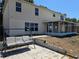 Backyard patio with furniture near the screened in lanai provides a space for outdoor living at 2018 Knollcrest Dr, Clermont, FL 34711