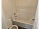 Small bathroom with white tub, matching tile surround, and a standard toilet at 2018 Knollcrest Dr, Clermont, FL 34711