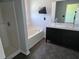 Bright bathroom with a double vanity, soaking tub, separate shower, and contemporary fixtures at 2018 Knollcrest Dr, Clermont, FL 34711