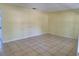 Large bedroom with neutral tile flooring and bright sunny windows at 2018 Knollcrest Dr, Clermont, FL 34711