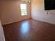 Bright bedroom with wood-look floors, a ceiling fan, and a large window at 2018 Knollcrest Dr, Clermont, FL 34711
