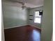 Bedroom with laminate floors, a ceiling fan, and a large window overlooking the side yard at 2018 Knollcrest Dr, Clermont, FL 34711
