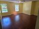 Spacious bedroom with laminate floors, ceiling fan, and large bright windows at 2018 Knollcrest Dr, Clermont, FL 34711