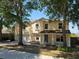 Inviting two-story home with a two-car garage and mature trees enhancing the curb appeal at 2018 Knollcrest Dr, Clermont, FL 34711