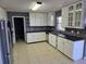 The kitchen boasts white cabinets and modern appliances, offering plenty of storage and style at 2018 Knollcrest Dr, Clermont, FL 34711