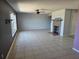 Open living room featuring neutral tile flooring, a fireplace, a ceiling fan, and ample natural light at 2018 Knollcrest Dr, Clermont, FL 34711