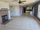 Open-concept living area with tile flooring, fireplace and seamless flow to kitchen, perfect for entertaining at 2018 Knollcrest Dr, Clermont, FL 34711