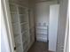 Spacious walk-in closet with white shelving and ample storage space for an organized wardrobe at 2018 Knollcrest Dr, Clermont, FL 34711