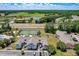 Overhead view featuring tennis court and playground next to blue and pink condo buildings, and ample parking spaces at 2028 Royal Bay Blvd # 85, Kissimmee, FL 34746