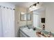 Well lit bathroom with shower-tub combo and large mirror at 2028 Royal Bay Blvd # 85, Kissimmee, FL 34746
