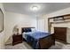 Cozy bedroom featuring a wooden bed frame, neutral walls, and an organized closet with dresser at 2028 Royal Bay Blvd # 85, Kissimmee, FL 34746