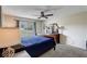 Bedroom with a dark wood bed frame and dresser, with lots of natural light at 2028 Royal Bay Blvd # 85, Kissimmee, FL 34746