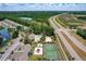 High-angle showcases community amenities: pond, pool, tennis court, and playground alongside residential buildings at 2028 Royal Bay Blvd # 85, Kissimmee, FL 34746