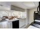 Open concept kitchen with appliances and a breakfast bar with a view of the living and dining room at 2028 Royal Bay Blvd # 85, Kissimmee, FL 34746