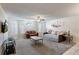 Cozy living room featuring neutral carpet, ceiling fan, and natural light at 2028 Royal Bay Blvd # 85, Kissimmee, FL 34746