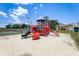 Playground featuring slides and climbing structures in a sandy play area at 2028 Royal Bay Blvd # 85, Kissimmee, FL 34746
