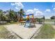 Playground featuring a blue and yellow swing set surrounded by sand and grass at 2028 Royal Bay Blvd # 85, Kissimmee, FL 34746