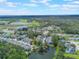 An elevated shot showing the townhome community, adjacent highway, and green areas extending to the horizon at 2047 Royal Bay Blvd # 21, Kissimmee, FL 34746