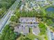 A full aerial view of well-maintained townhomes with parking, ponds, and green spaces by highway at 2047 Royal Bay Blvd # 21, Kissimmee, FL 34746