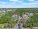 Wide aerial view of the townhome community with lush trees and a serene lake creating a peaceful environment at 2047 Royal Bay Blvd # 21, Kissimmee, FL 34746