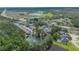 Wide aerial shot of townhome community with surrounding trees, a lake, and a highway at 2047 Royal Bay Blvd # 21, Kissimmee, FL 34746