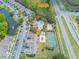 An aerial view of apartment homes with a community pool, a playground, tennis court, and highway at 2047 Royal Bay Blvd # 21, Kissimmee, FL 34746