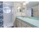 Bathroom featuring a walk-in shower with round window and sink with ample counter space at 2047 Royal Bay Blvd # 21, Kissimmee, FL 34746