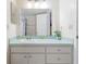 Bathroom featuring a spacious sink with ample counter space, large mirror, and access to shower at 2047 Royal Bay Blvd # 21, Kissimmee, FL 34746