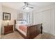 Cozy bedroom with a queen bed, ceiling fan, nightstand, and closet at 2047 Royal Bay Blvd # 21, Kissimmee, FL 34746