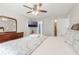 Cozy bedroom featuring a ceiling fan, TV, and access to the bathroom at 2047 Royal Bay Blvd # 21, Kissimmee, FL 34746