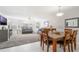 Open-concept dining area with tile floors and view to a living room with large windows at 2047 Royal Bay Blvd # 21, Kissimmee, FL 34746