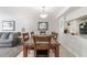 Dining area with a wooden table, six chairs, and an open view to the living room at 2047 Royal Bay Blvd # 21, Kissimmee, FL 34746