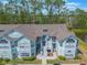 Charming light-blue condo complex featuring large windows and access to an outdoor staircase with water views at 2047 Royal Bay Blvd # 21, Kissimmee, FL 34746