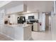 Bright kitchen with a breakfast bar, black appliances, and neutral countertops and floors at 2047 Royal Bay Blvd # 21, Kissimmee, FL 34746