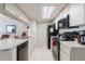 Bright kitchen featuring white cabinets, black appliances, and a convenient breakfast bar at 2047 Royal Bay Blvd # 21, Kissimmee, FL 34746