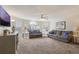 Spacious living room with natural light, plush sofas, and a ceiling fan at 2047 Royal Bay Blvd # 21, Kissimmee, FL 34746