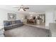 Open-concept living area with ceiling fan, gray sofa, and adjacent dining space at 2047 Royal Bay Blvd # 21, Kissimmee, FL 34746