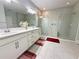 Modern bathroom with double vanity, a large walk-in shower with dual shower heads, and neutral tiling at 2445 Verde View Dr, Apopka, FL 32703