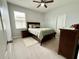 Cozy bedroom with neutral walls, carpeted floors, and a dark wood dresser at 2445 Verde View Dr, Apopka, FL 32703