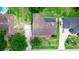 Aerial view of a home with solar panels and a long driveway in a well-maintained neighborhood at 2621 Ardon Ave, Orlando, FL 32833