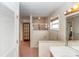 Bright bathroom featuring a tiled walk-in shower, tile flooring, and a vanity with ample lighting at 2621 Ardon Ave, Orlando, FL 32833