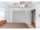 Inviting bedroom with a ceiling fan, white walls, a large closet, and hardwood flooring adding warmth and character at 2621 Ardon Ave, Orlando, FL 32833